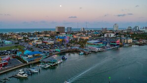 A coastal cityscape with a marina, boats, and buildings.