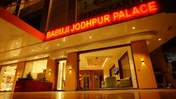 The exterior of Babuji Jodhpur Palace with a prominent illuminated sign.