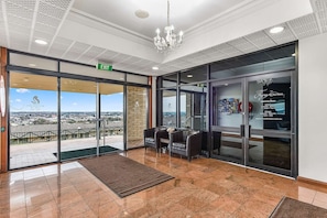 A hotel lobby with a reception desk, seating area, and a view of the cityscape. - Comfort Inn The Lakes (Mount Gambier)