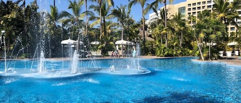 Relax by the pool surrounded by lush palm trees and enjoy the soothing water jets.