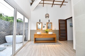 A modern bathroom with a wooden vanity, two sinks, and a large window. - Ban Mai Beach Villa Phu Quoc (Phu Quoc)