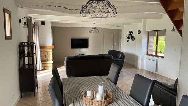 A dining area with a patterned tablecloth, black chairs, and a central candle holder. - Gîte near Le Treport and Criel sur Mer (Saint-Martin-le-Gaillard)