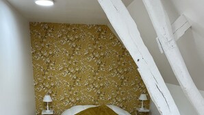 A bedroom with a bed, two bedside lamps, a wooden floor, and a floral wallpaper. - Gîte near Le Treport and Criel sur Mer (Saint-Martin-le-Gaillard)