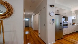 A modern kitchen with stainless steel appliances, wooden cabinets, and a built-in oven. - La Belle aimante, beautiful home with pool (HORSESHOE BAY)