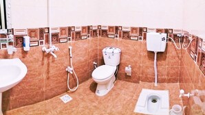 A bathroom with a toilet, bidet, and sink. - Subhan Palace Guest House (Dubai)