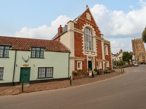 A historic building with a prominent arched window and a clock tower. - Bodkin Cottage (Minehead)