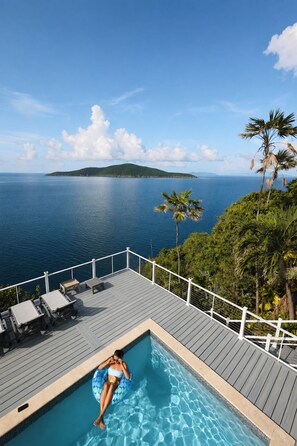 A pool area with a view of the ocean and a distant island. - Ocean Views & Breezes, Pool, Huge Deck, Serenity (St. Thomas)