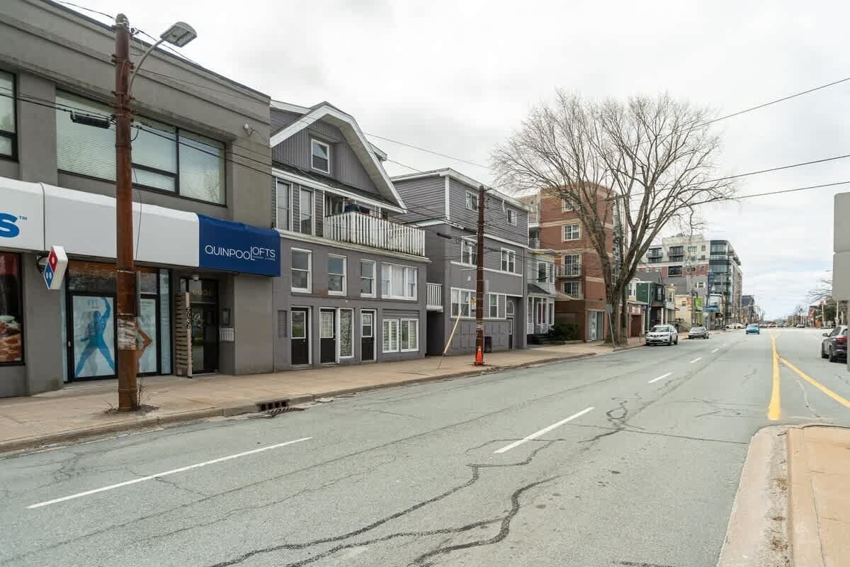A street with buildings, a visible storefront with signage, and a clear road.