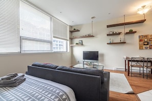 Relax in this inviting living room with a comfortable sofa, dining area, and flat-screen TV.