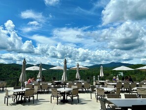Outdoor dining - At Fireside Lodge, experience pet-friendly luxury with a majestic mountain vista, hot tub, outdoor fireplace, firepit, pool table, and seamless WiFi (Ellijay)