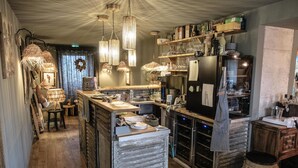 A cozy restaurant with rustic decor, wooden furniture, and hanging light fixtures. - La Cambrousse (Villers-la-Chèvre)