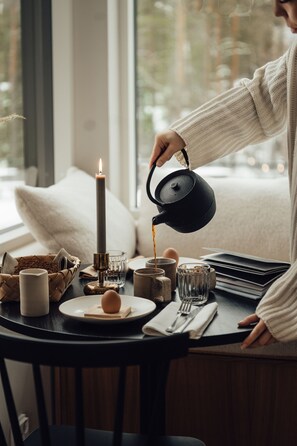 Une table avec une bougie, une théière et une tasse.