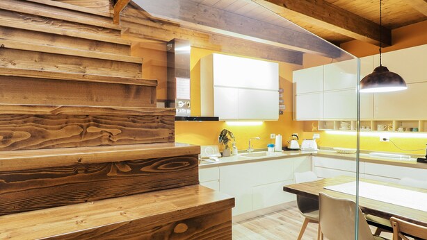 A modern kitchen with wooden cabinetry, a wooden countertop, and a glass partition. - Domu Mea - Morada - Two Bedroom House, Sleeps 4 (Iglesias)