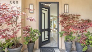 A hotel entrance with a black-framed door, numbered 1088, and potted plants on either side. - 3885 Pebble Beach Oasis - Indoor / Outdoor Living (Pebble Beach)