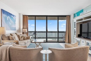 Enjoy ocean views from the large balcony and relax in the comfortable seating area with a sofa and armchairs.