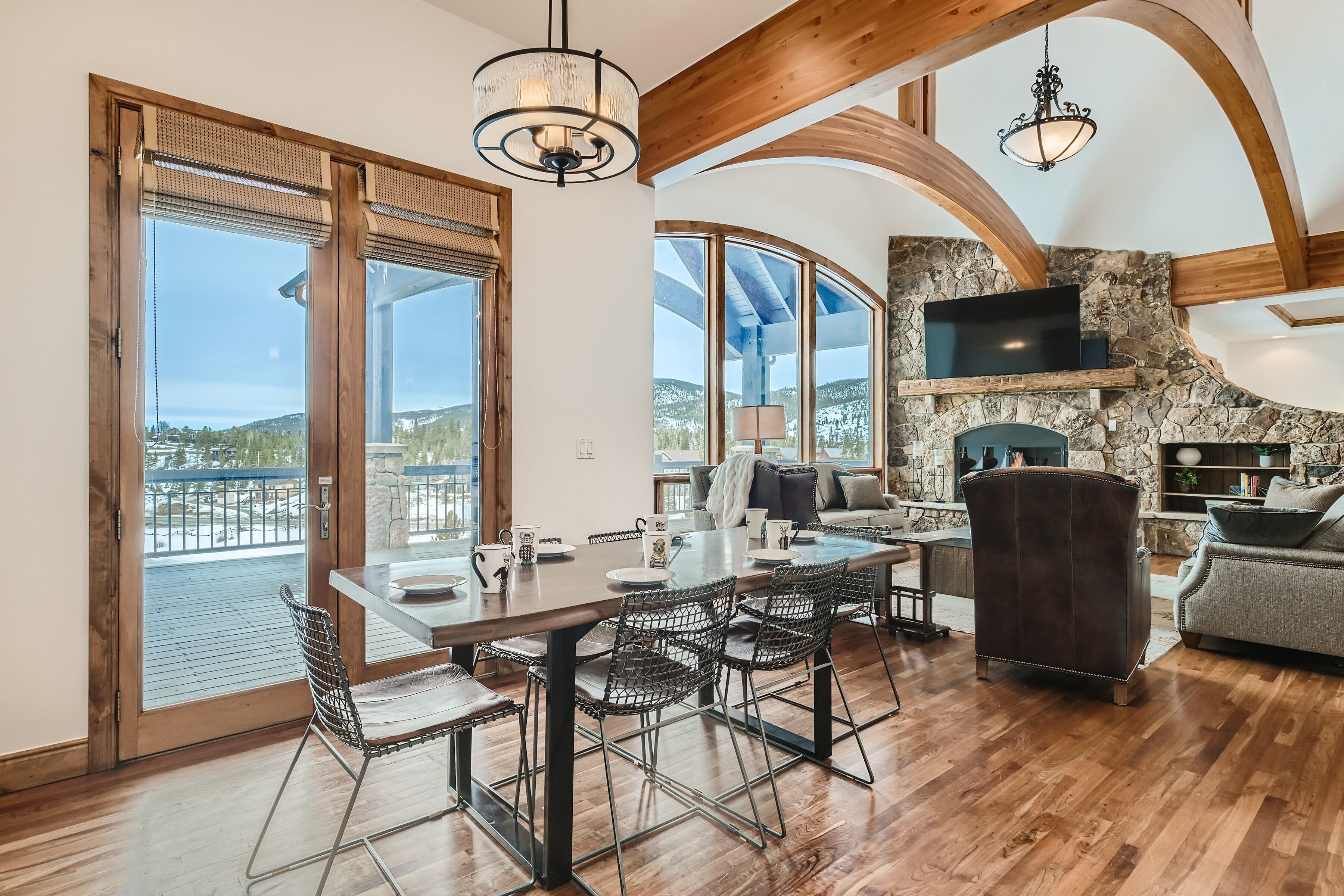 A spacious living area with a dining table, chairs, and a fireplace.
