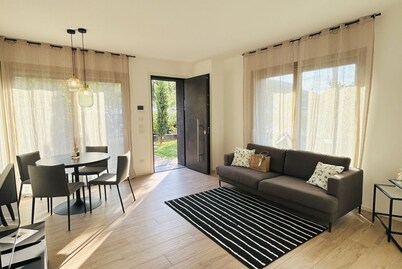 Elegant newly built apartment, located on the ground floor. Internally it consists of entrance on living room and kitchenette, double bedroom, twin bedroom, two bathrooms with shower. To complete the property large private garden and double outdoor parki