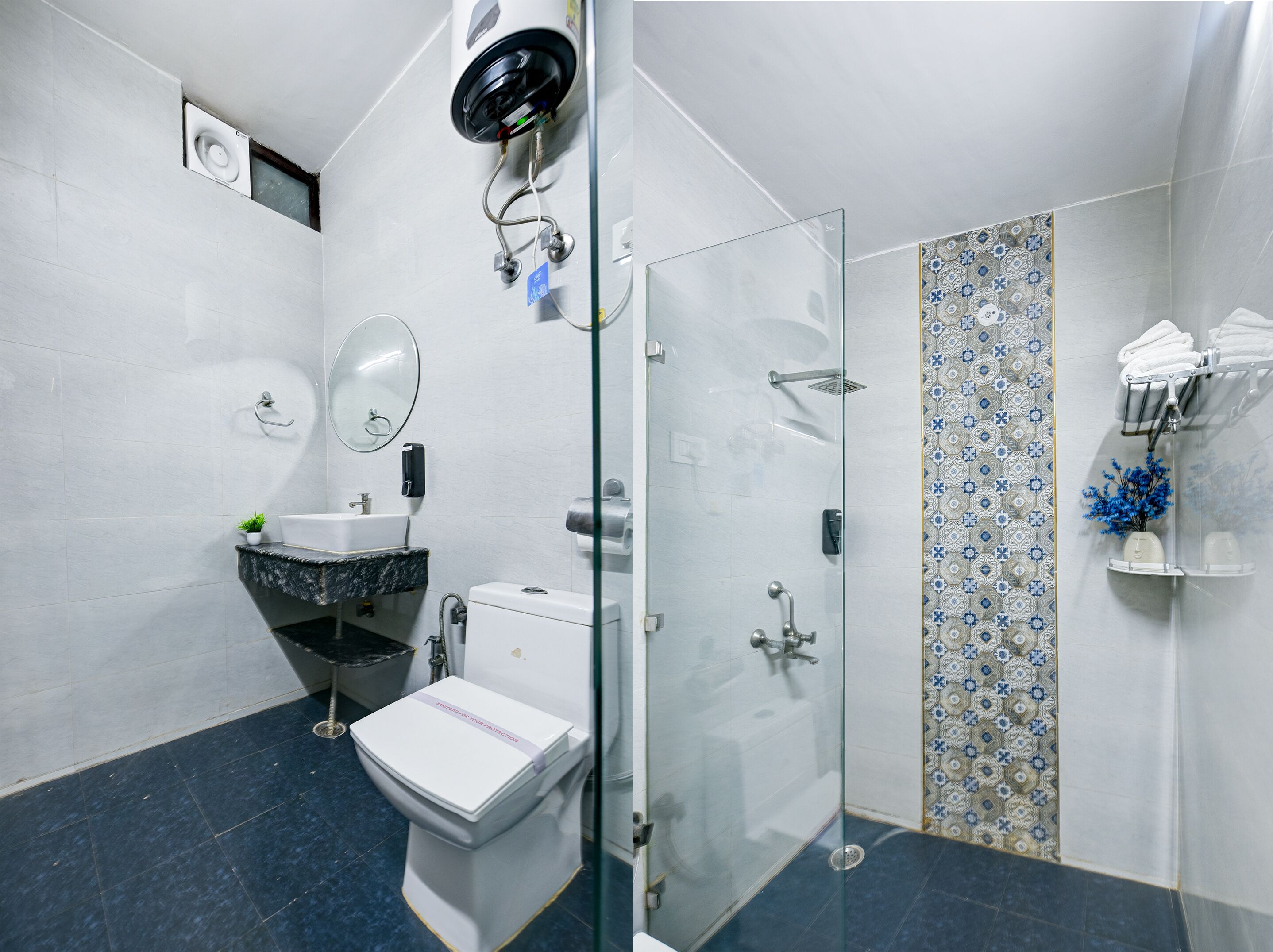 Une salle de bain comprenant des toilettes, un lavabo et une douche séparée par une paroi en verre.