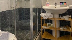 A shower with glass doors, a sink with a mirror above, and a shelf with toiletries. - Apartment In A Hotel 'Sunset Triple 2' with Sea View, Wi-Fi and Air Conditioning (Lefkada)