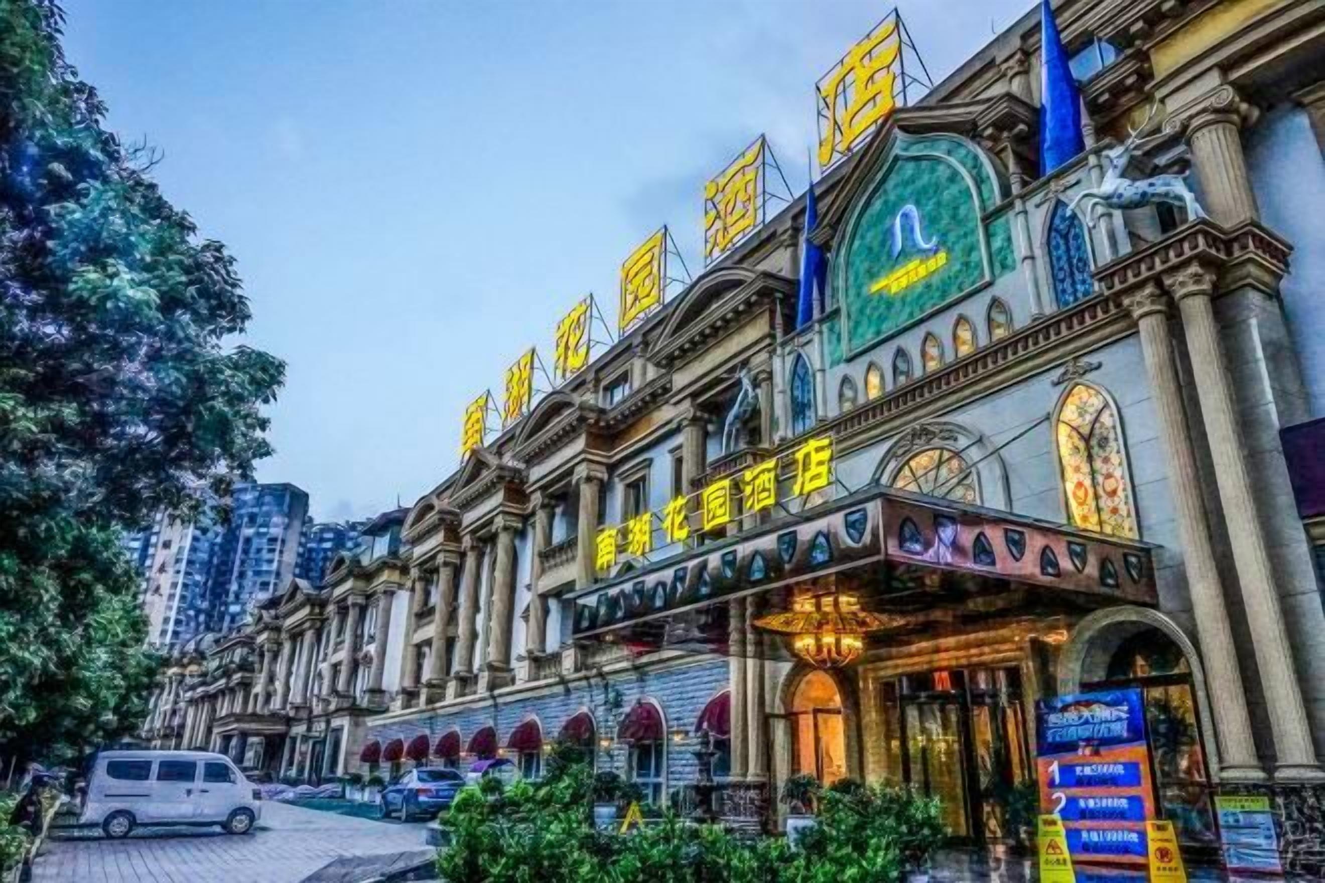 A historic building with classical architecture, a prominent green sign, and a balcony with a railing.