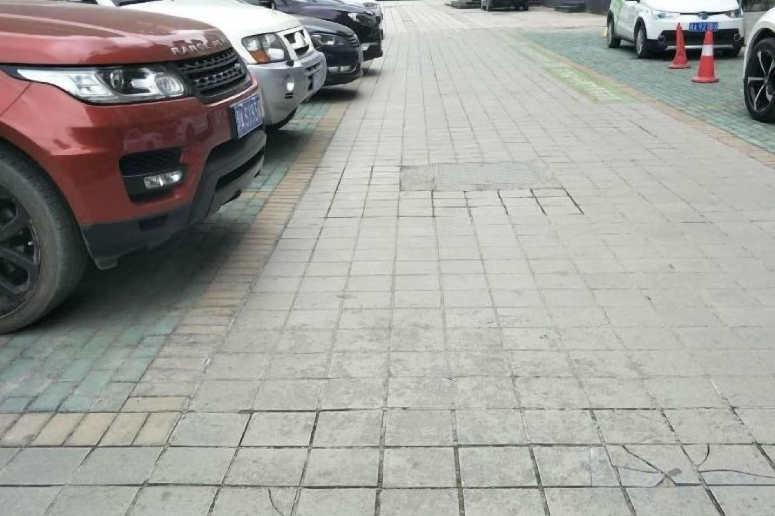A parking area with vehicles parked in rows.