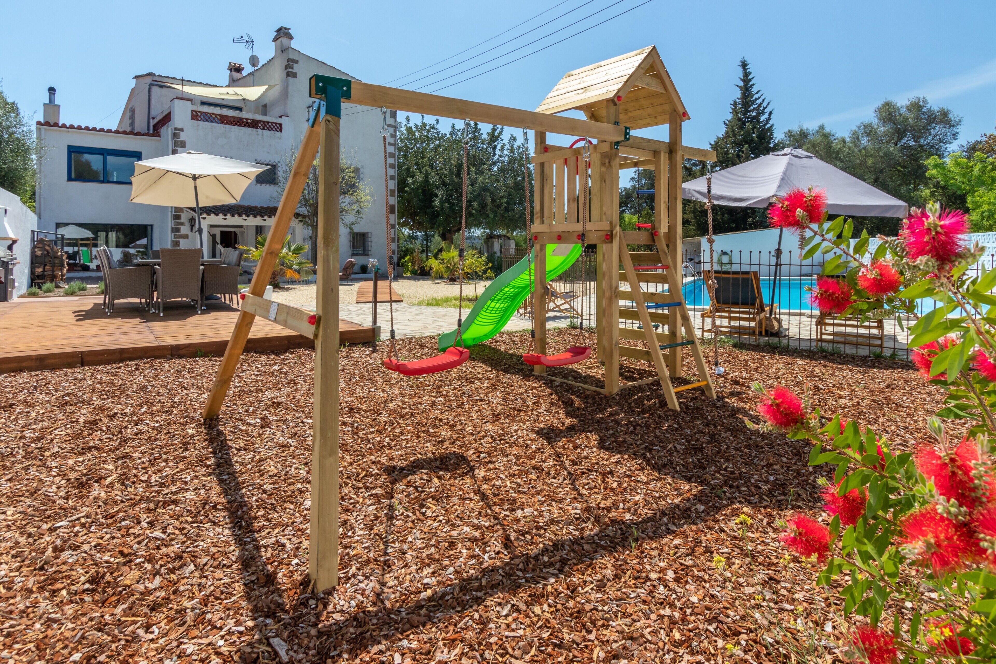 A playground with a slide, swings, and a climbing structure.