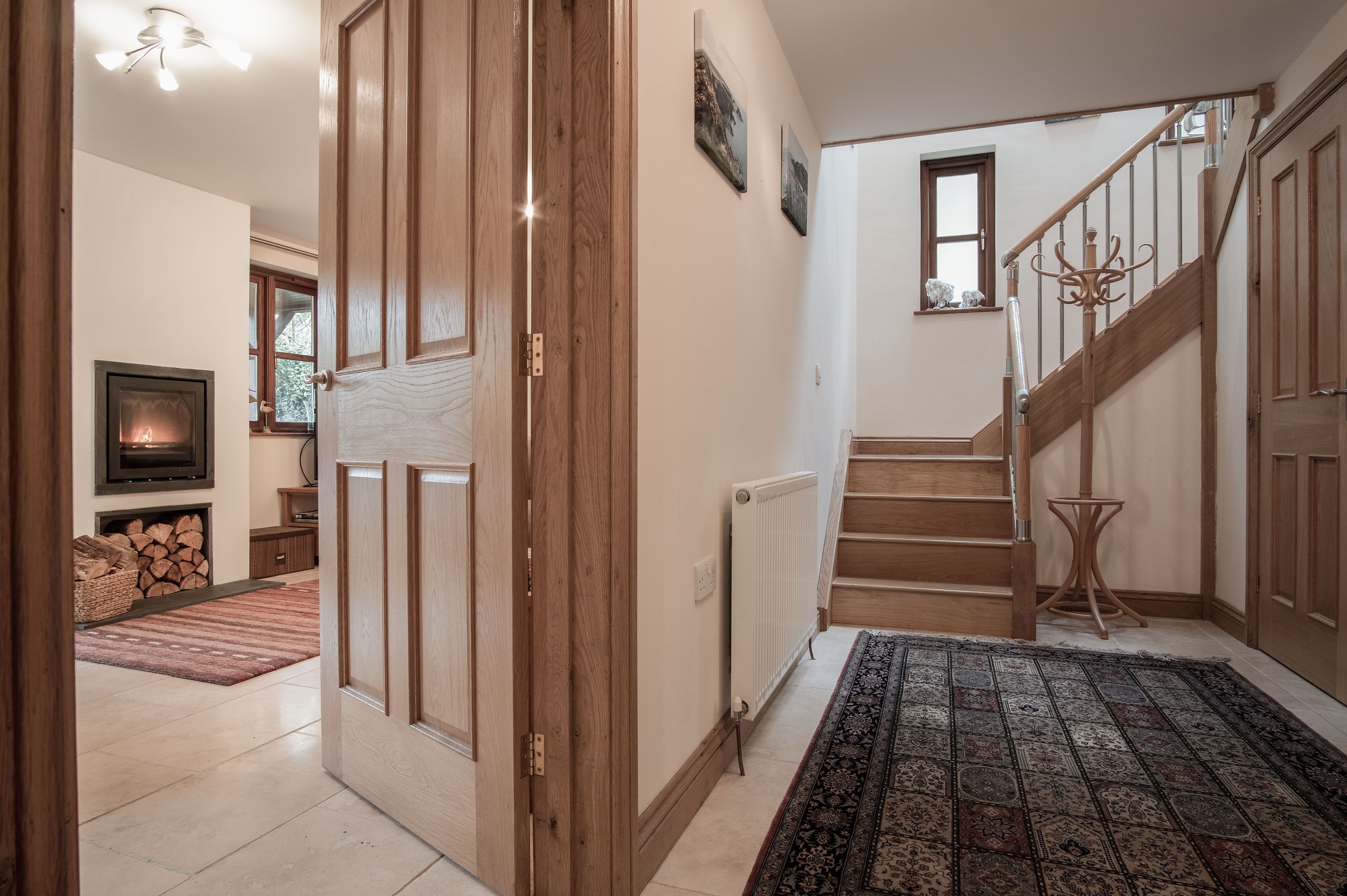 A staircase with wooden railings and a handrail, leading to an upper floor.