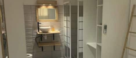 A narrow, modern bathroom with a toilet, sink, and mirror. There are built-in shelves and a ladder leaning against the wall.