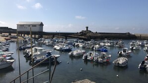 A marina with numerous boats docked, a lighthouse, and a building labeled "SAUVETAGE EN MER". - House near beaches, classified 3*- quiet (Névez)