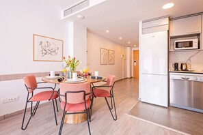 A modern kitchen with a stainless steel refrigerator, microwave, and coffee maker.