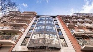 A high-rise residential building with multiple balconies, large windows, and a modern architectural design. - Sweett | Fira 401 - Two Bedroom Apartment, Sleeps 5 (Barcelona)