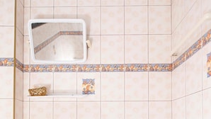 A bathroom with a sink, toilet, and a mirror. - OYO 325 Naiyang Cottage (Sa Khu)
