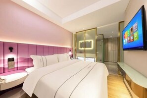 A modern hotel room with a large bed, a bedside table, a TV mounted on the wall, and a glass partition separating the room from the hallway. - Langfeng Capital Hotel Zhongshan (Former Sun Yat-sen · Nanlang Station Branch) (Zhongshan)