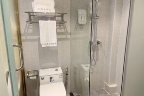 A glass-enclosed shower stall with a handheld showerhead, a towel rack with a white towel, and a soap dispenser on the wall. - Langfeng Capital Hotel Zhongshan (Former Sun Yat-sen · Nanlang Station Branch) (Zhongshan)