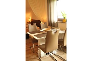 Enjoy meals in the dining area with a table for four and a side table.