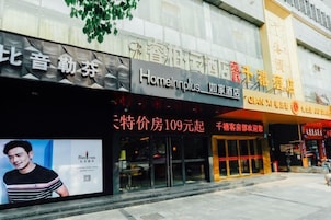 Fachada de hotel con señalización de 'Homeinnplus' y 'Cian Xiang Hotel'.