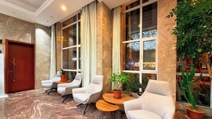 A lobby with marble flooring, large windows, and seating arrangements. - Kaibin International Hotel (Xining)