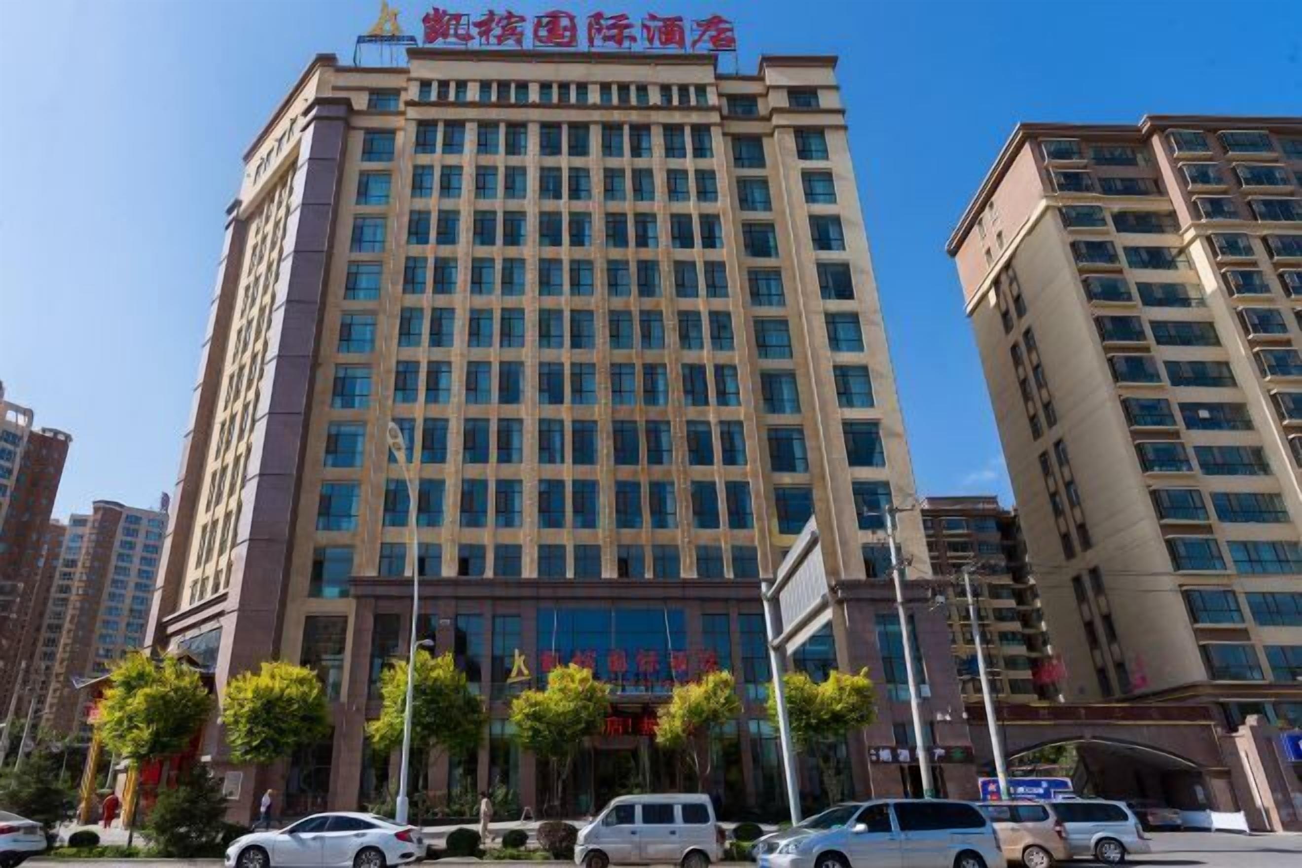 A multi-story hotel with a modern facade, large windows, and a prominent entrance.