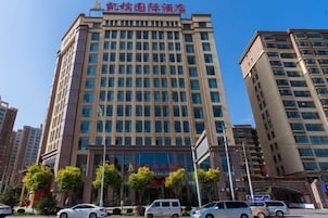 A multi-story hotel with a modern facade, large windows, and a prominent entrance.