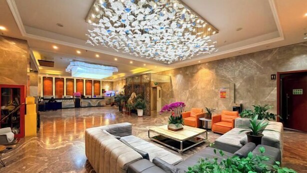 A spacious lobby with a marble floor, a reception desk, and a modern chandelier. - Kaibin International Hotel (Xining)
