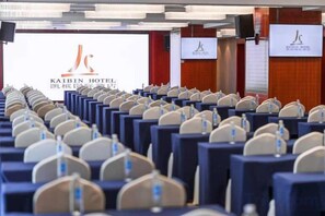 A conference room with rows of chairs facing a projection screen displaying the logo of the Kaibin Hotel. - Kaibin International Hotel (Xining)