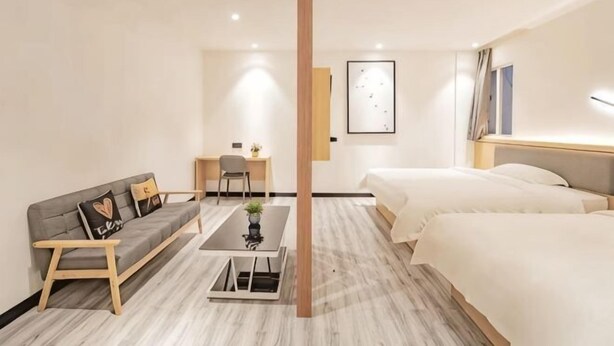 A hotel room with a bed, a sofa, a desk, and a chair. - Changee Hotel (Haikou Qilou Old Street Nanya Plaza) (Haikou)