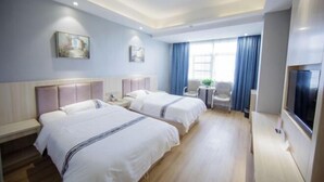 A hotel room with two beds, a desk, a chair, a TV, and a window with curtains. - Jinghe Holiday Hotel (Wuhan)
