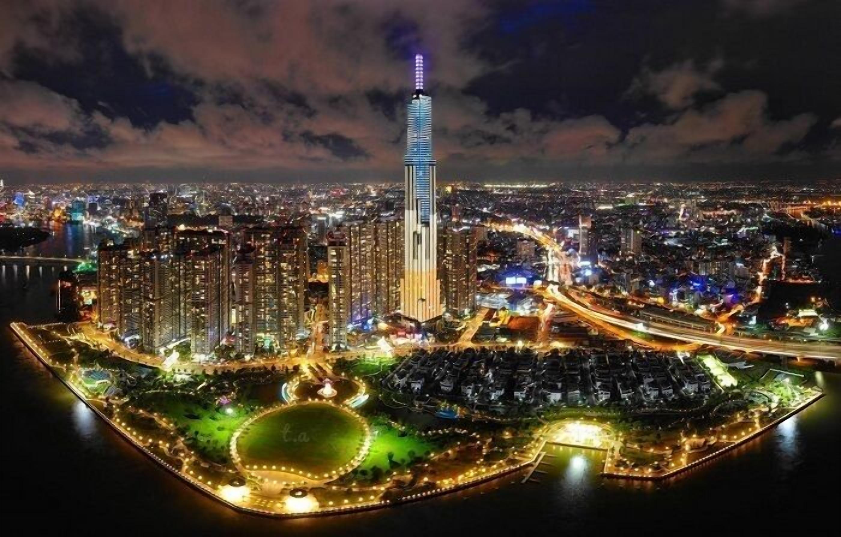 A nighttime cityscape with a prominent skyscraper, a waterfront promenade, and a large circular park.