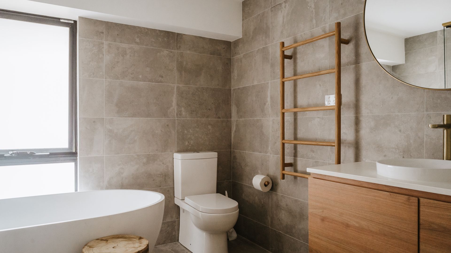 A modern bathroom with a toilet, sink, and bathtub.