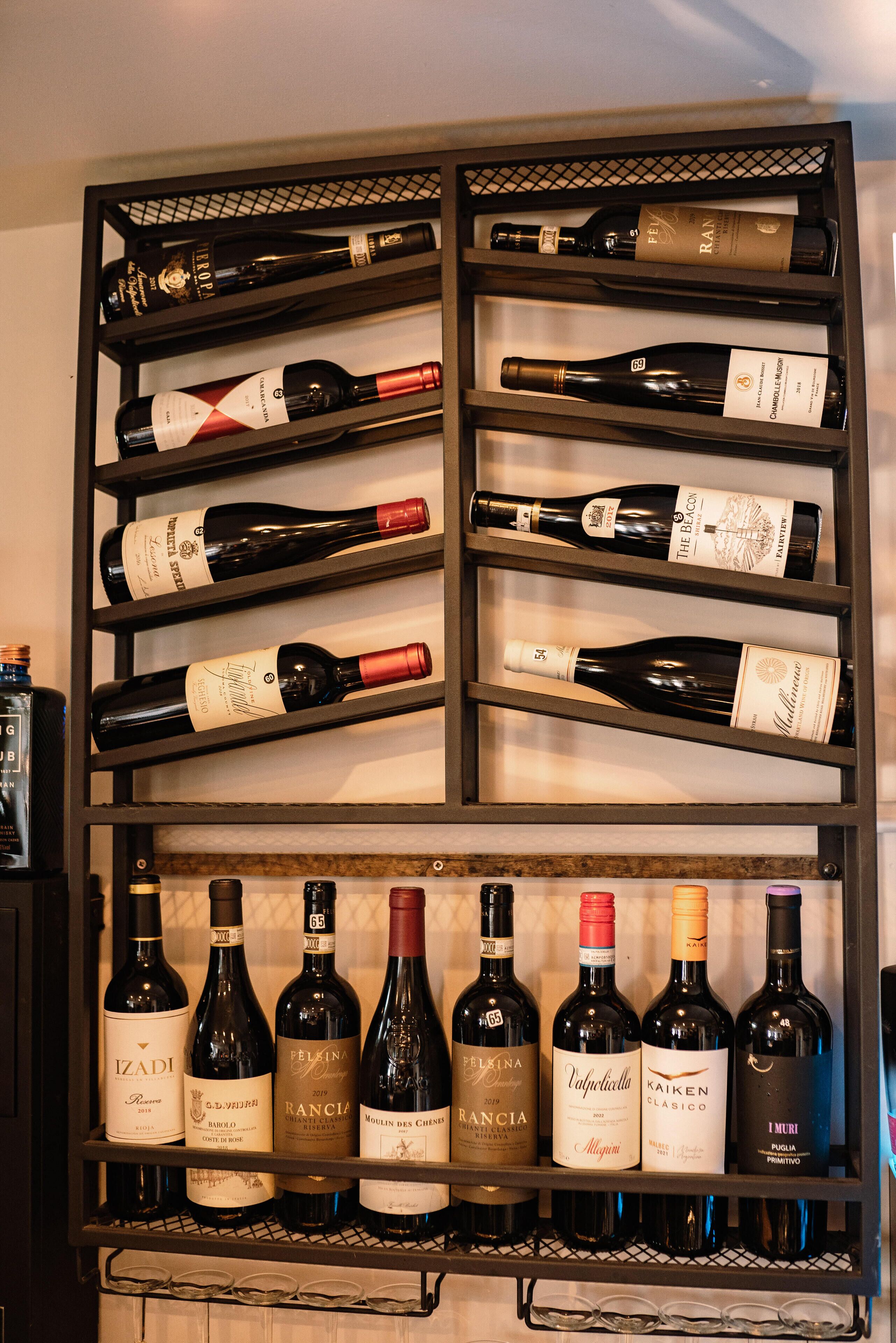 A wine rack with multiple bottles of wine.