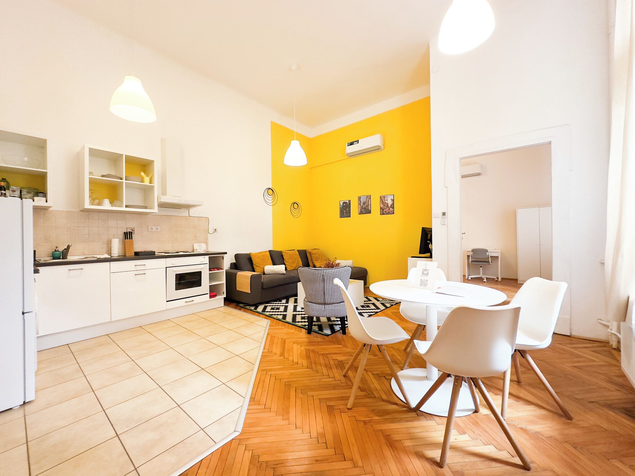 A modern apartment with a kitchen, dining area, and living space.