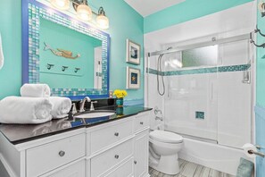 Bathtub, hair dryer, towels, shampoo