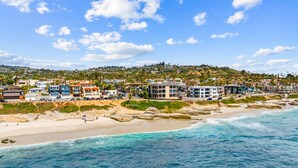 A coastal town with beachfront properties, clear blue skies, and rocky shoreline. - Windansea Luxury Beach Home  - Spa, AC, Walk to Beach, Garage & Fast WiFi! (La Jolla)