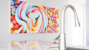 A bathroom with a modern sink and a wall-mounted mirror. - Candy Land- Downtown ILM (Wilmington)